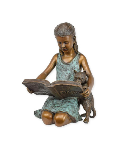 Bronzen meisje beeld dat in dagboek leest